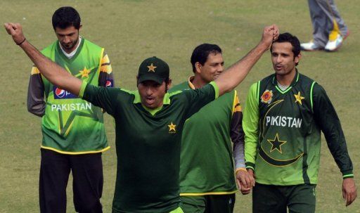 Pakistan bowler Mohammad Irfan stretches during a practice session in Lahore on December 15, 2012