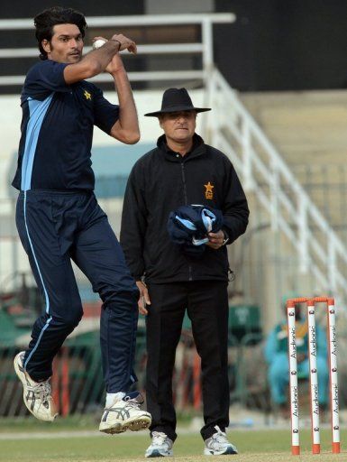 Pakistan bowler Mohammad Irfan delivers a ball during a practice session in Lahore on December 17, 2012