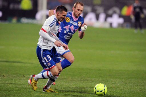 Lyon&#039;s forward Anthony Reveillere (L) clashes with Evian&#039;s midfielder Olivier Sorlin on January 18, 2013 in Lyon