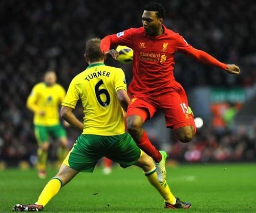 Liverpool's Daniel Sturridge (R) is tackled by Norwich City's Michael Turner in Liverpool on January 19, 2013