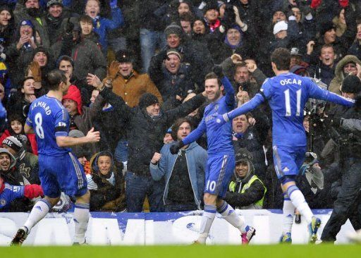 Chelsea&#039;s Juan Mata celebrates scoring during their match against Arsenal in London on January 20, 2013