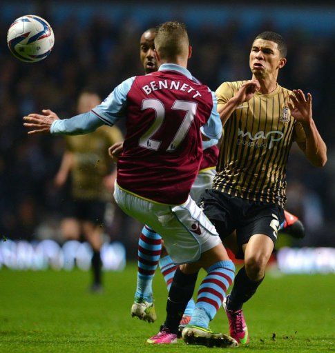 Aston Villa&#039;s Joe Bennett (L) challenges Bradford City&#039;s Nahki Wells at Villa Park, Birmingham, on January 22, 2013