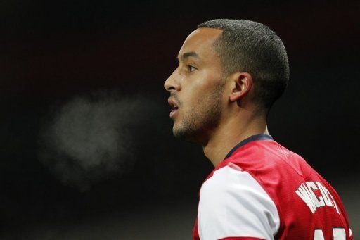 Theo Walcott prepares to take a free-kick during the FA Cup third-round replay against Swansea City on January 16, 2013