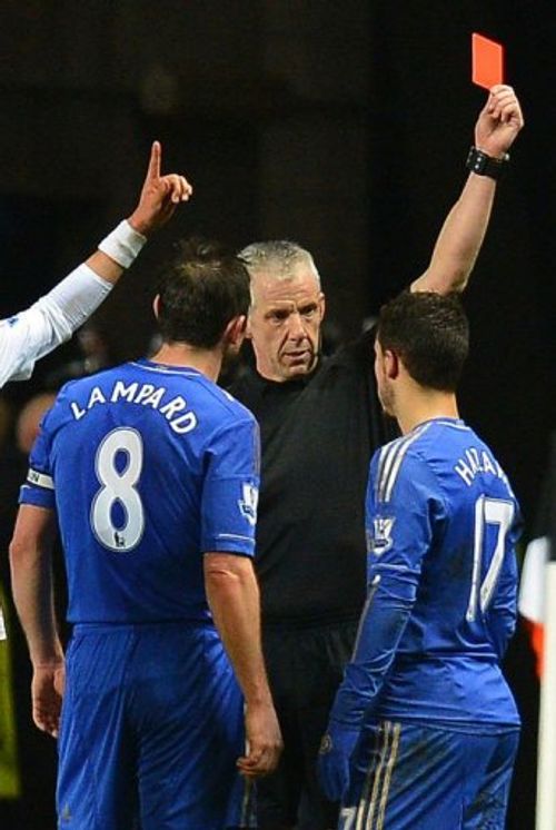 Chelsea's Eden Hazard (R) is sent off by referee Chris Foy (C) in Cardiff, south Wales on January 23, 2013