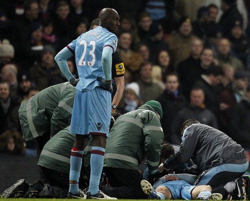 West Ham United&#039;s Daniel Potts receives treatment at The Emirates Stadium in London on January 23, 2013