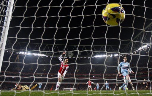 Arsenal&#039;s Theo Walcott scores their  fourth goal during a a 5-1 thrashing of West Ham United, January 23, 2013