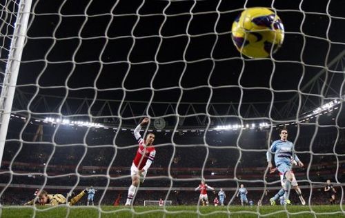 Arsenal's Theo Walcott scores their  fourth goal during a a 5-1 thrashing of West Ham United, January 23, 2013