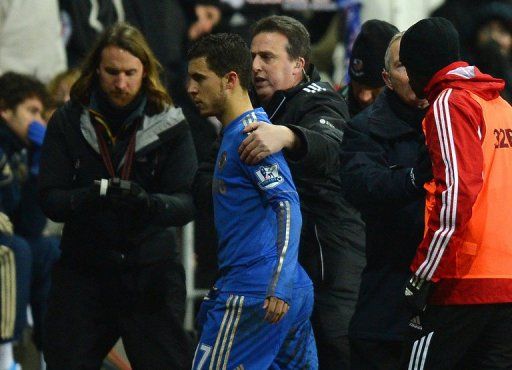 Chelsea&#039;s Eden Hazard (C) is escorted off the pitch after being sent off by referee, in Cardiff, on January 23, 2013