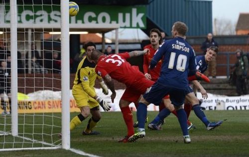 Oldham's Matt Smith (R) scores against Liverpool in the FA Cup fourth round at Boundary Park on January 27, 2013