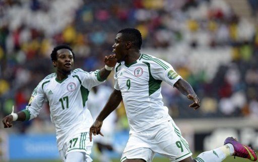 Nigeria forward Emmanuel Emenike (R) celebrates after scoring a goal against Zambia on January 25, 2013