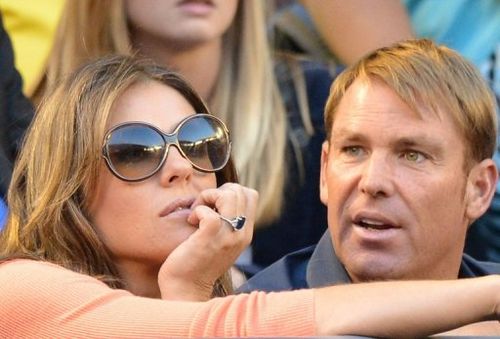 Shane Warne and Elizabeth Hurley watch Roger Federer in action at the Australian Open in Melbourne on January 19, 2013