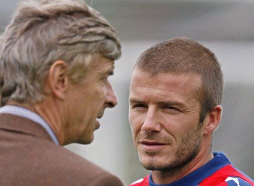 David Beckham (right) talks with Arsene Wenger during training at London Colney, north of London, on August 20, 2007