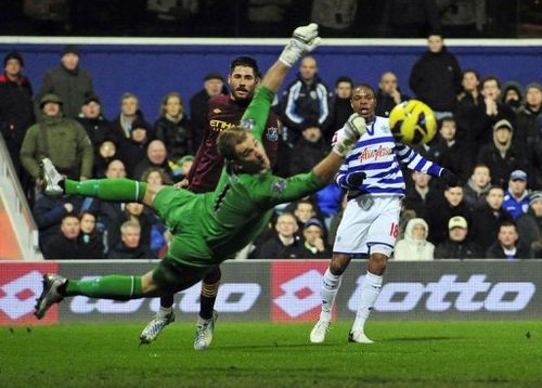 QPR's Loic Remy (R) watches his shot go wide of Manchester City's Joe Hart (L) in London on January 29, 2013.