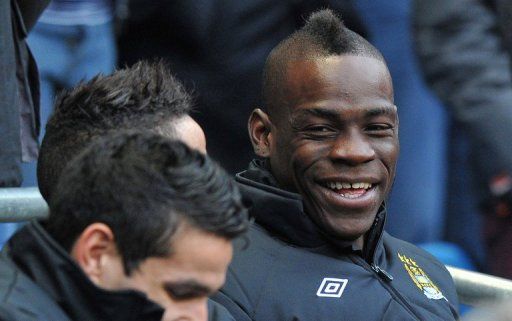Manchester City striker Mario Balotelli smiles before the FA Cup third-round match at home to Watford on January 5, 2013