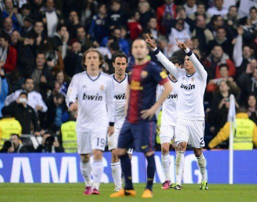 Real Madrid&#039;s Raphael Varane (R) celebrates after scoring in Madrid on January 30, 2013