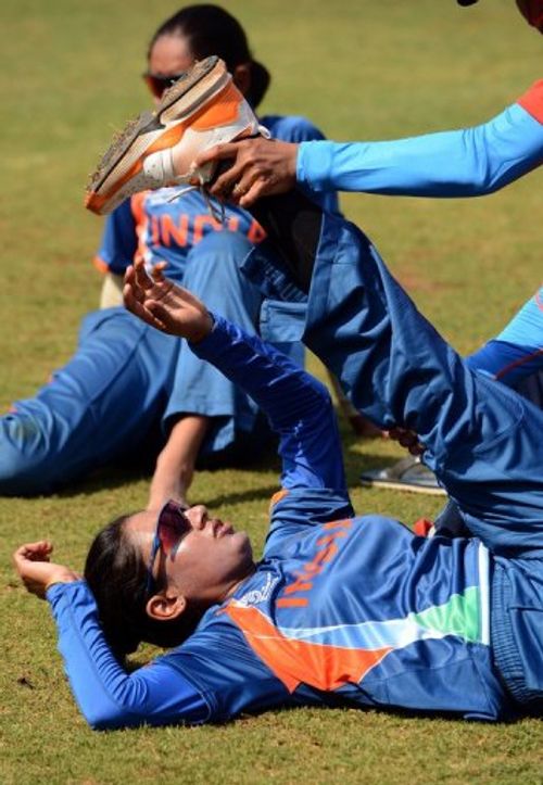 India women's cricket team captain Mithali Raj gets some help to stretch after a  training session on January 22, 2013