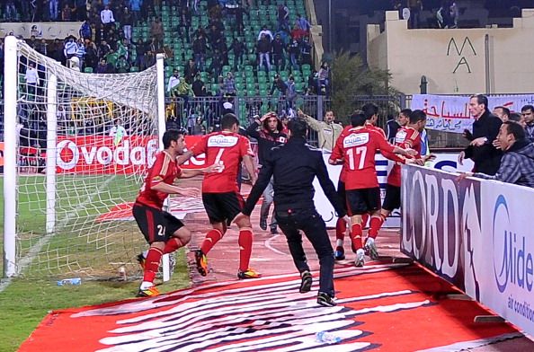 Egyptian Al-Ahly players escape from the