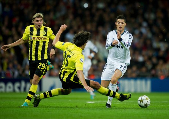 Mats Hummels (L) of Borussia Dortmund tackles Cristiano Ronaldo of Real Madrid during the UEFA Champions League group D match between Real Madrid and Borussia Dortmund at Estadio Santiago Bernabeu on November 6, 2012 in Madrid, Spain.