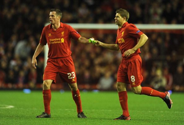 Jamie Carragher passes the Captains arm band to Steven Gerrard