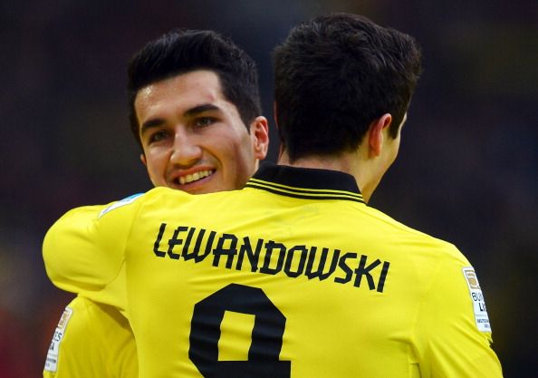 Nuri Sahin of Dortmund smiles with Robert Lewandowski during a Bundesliga match