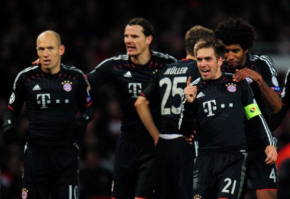 LONDON, ENGLAND - FEBRUARY 19:  Philipp Lahm of Bayern Muenchen celebrates after team-mate Mario Mandzukic scored their third goal during the UEFA Champions League round of 16 first leg match between Arsenal and Bayern Muenchen at Emirates Stadium on February 19, 2013 in London, England. 