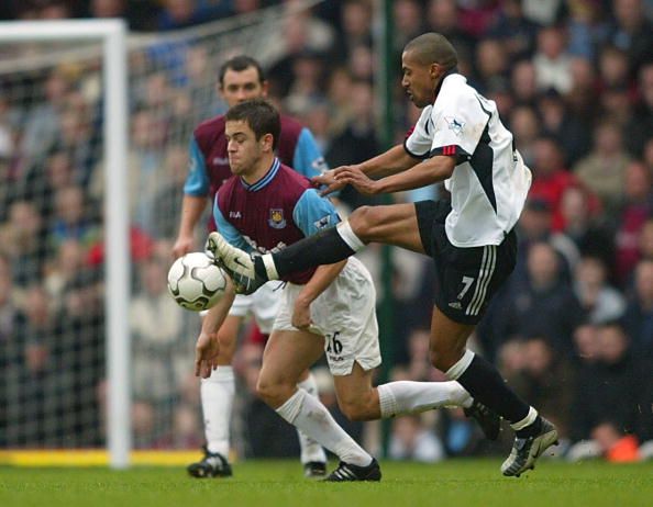 Joe Cole is challenged by Steve Marlet