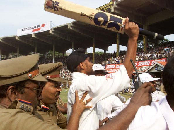 22 Mar 2001:  Harbhajan Singh of India is escorted from the field after hitting the winning runs, during day five of the third test between India and Australia at the M.A. Chidambaram Stadium, Chennai, India.