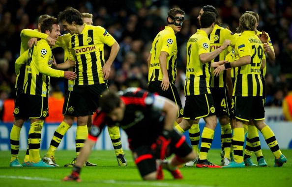 ario Gotze (2nd L) of Borussia Dortmund celebrates with his teammates after scoring his sides second goal as Goalkeeper Iker Casillas of Real Madrid sits dejected on the pitch during the UEFA Champions League group D match between Real Madrid and Borussia Dortmund