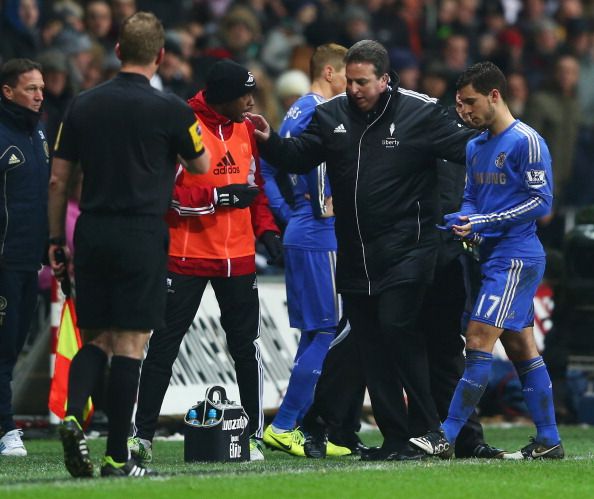Eden Hazard of Chelsea (R) is sent off after kicking the ball boy 