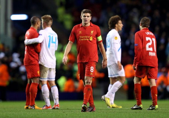LIVERPOOL, ENGLAND - FEBRUARY 21:  A dejected Steven Gerrard of Liverpool walks off the pitch following his team&#039;s exit from the competition during the UEFA Europa League round of 32 second leg match between Liverpool FC and FC Zenit St Petersburg