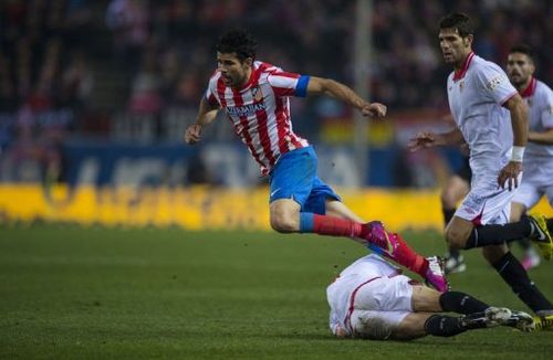 Atletico Madrid's Brazilian forward Diego Costa (L) is fouled in Madrid on January 31, 2013