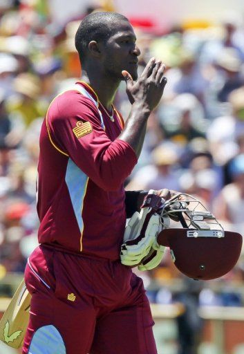 West Indies batsman Darren Sammy trudges off after losing his wicket against Australia on February 1, 2013