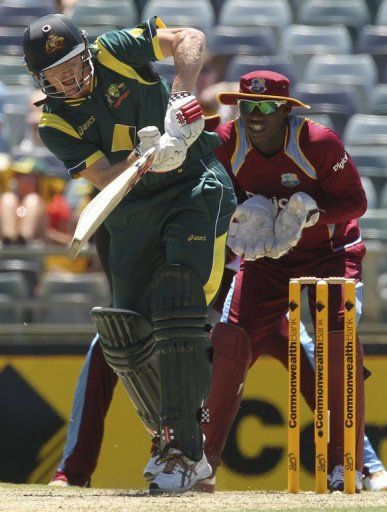 Australia&#039;s George Bailey (L) drives beside West Indies&#039; Johnson Charles during their ODI on February 3, 2013