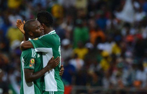 Nigeria&#039;s forward Sunday Mba (L) is congratulated by teammates after scoring a goal on February 3, 2013 in Rustenburg