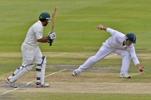 South Africa fielder Dean Elgar (R) catches the ball hit by Pakistan batsman Asad Shafiq on  February 3, 2013