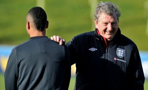 England manager Roy Hodgson (R) shares a joke with Ashley Cole during a training session on February 4, 2013