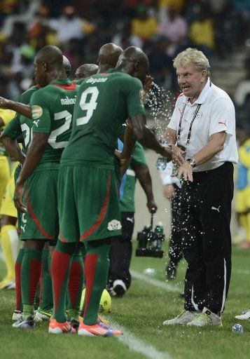 Burkina Faso coach Paul Put speaks to his players at the game against Togo in Nelspruit on February 3, 2013