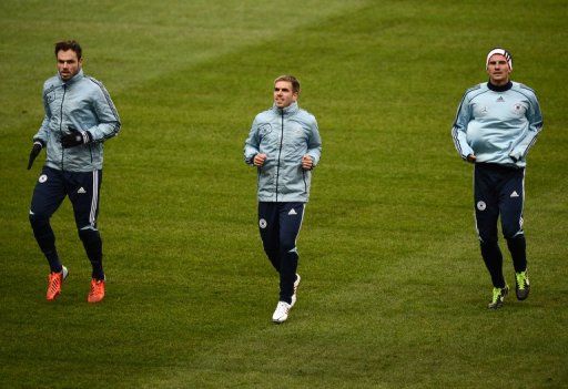(From L) Germany defender Heiko Westermann, captain Philipp Lahm and forward Mario Gomez train on February 5, 2013