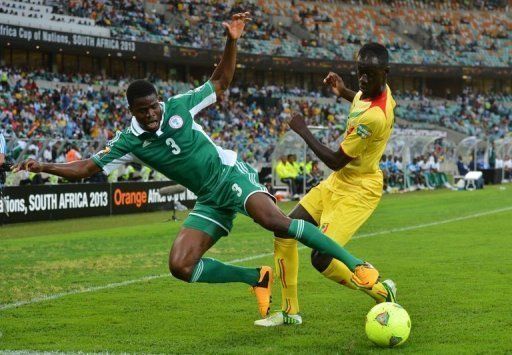 Elderson Echiejile (left) clashes with Fousseiny Diawara in the Cup of Nations semi-final in Durban on February 6, 2013