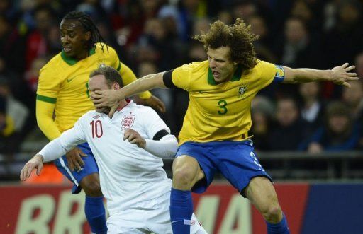 David Luiz (R) battles with England striker Wayne Rooney during the friendly at Wembley Stadium on February 6, 2013