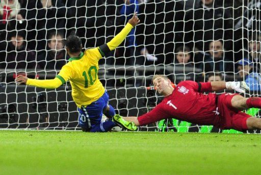 Joe Hart (R) saves Ronaldinho&#039;s attempts to follow up after Hart saved the Brazilian&#039;s penalty, on February 6, 2013