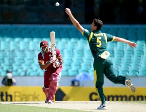 West Indies&#039; Kieron Pollard (L) drives a ball back to Ben Cutting during their ODI match in Sydney on February 8, 2013