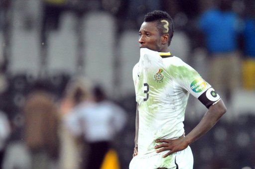 Asamoah Gyan cuts a dejected figure after Ghana went out on penalties in the semi-final on February 6, 2013