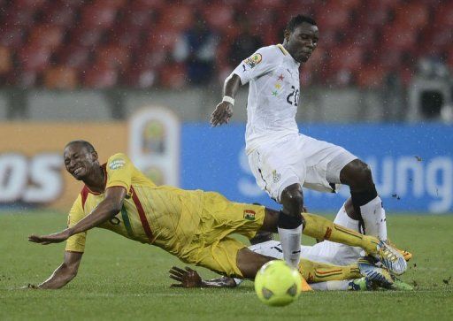 Ghana&#039;s midfielder Kwadwo Asamoah (R) is tackled by Mali&#039;s midfielder Kalilou Traore on February 9, 2013