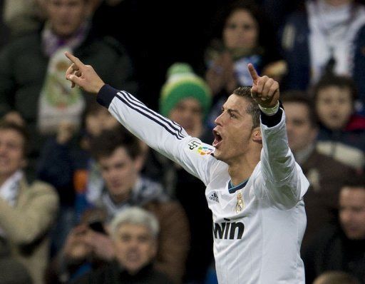 Real Madrid&#039;s forward Cristiano Ronaldo celebrates after scoring in Madrid on February 9, 2013