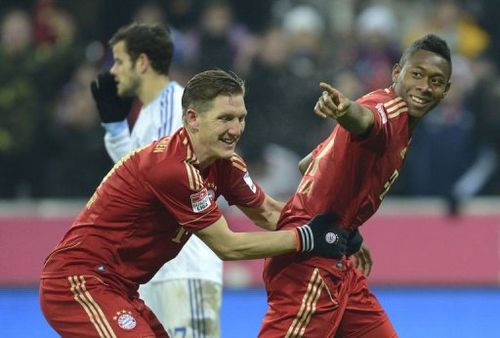 Bayern Munich's Bastian Schweinsteiger (L) and David Alaba celebrate in Munich, southern Germany, on February 9, 2013