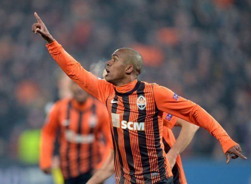 Douglas Costa of FC Shakhtar celebrates scoring against Borussia Dortmund during their UEFA Champions League round 16 football match in Donetsk on February 13, 2013. The match ended in a 2-2 draw.