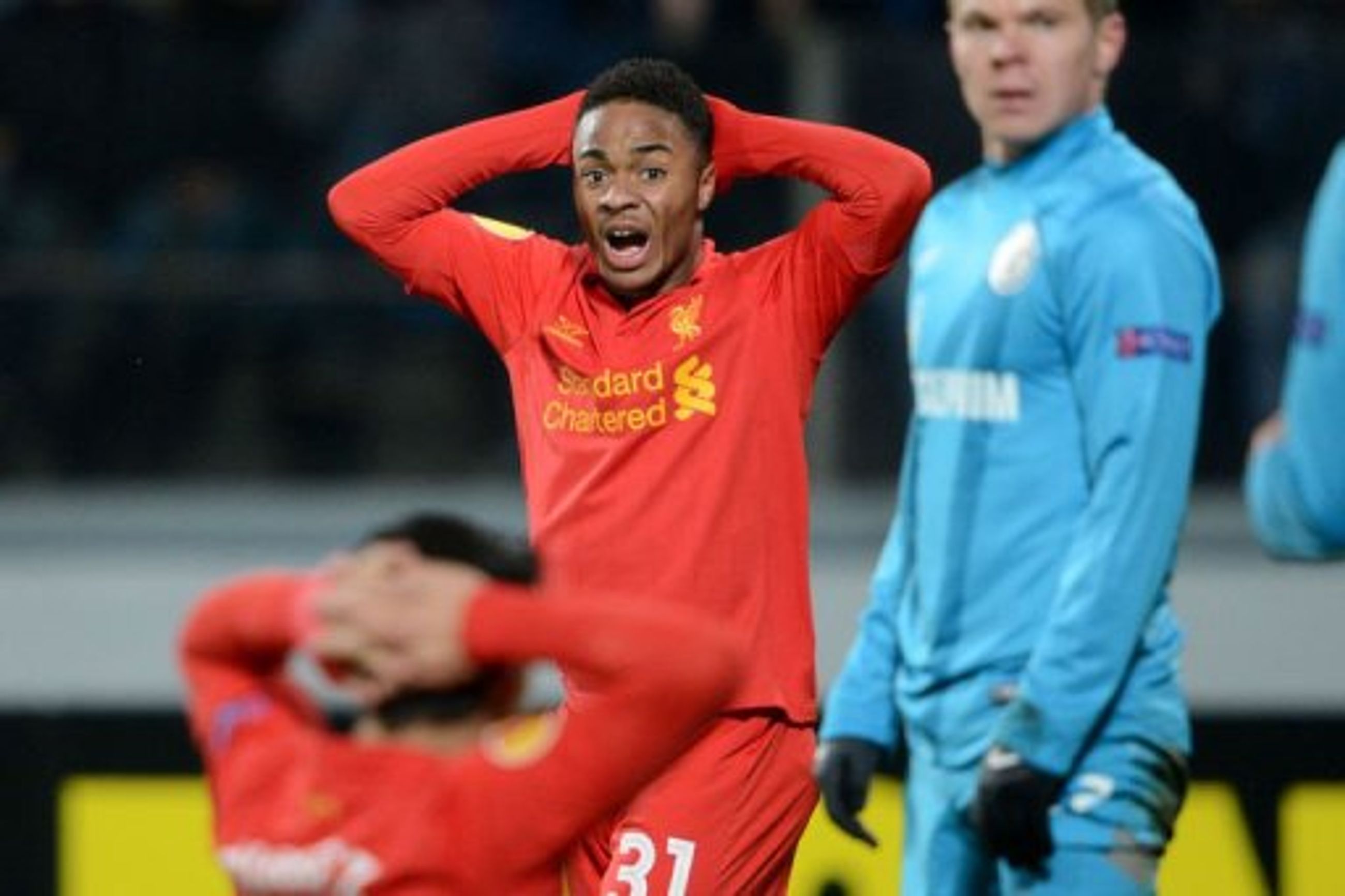 Liverpool&#039;s Raheem Sterling (C) and Luis Suarez (L) react in St. Petersburg on February 14, 2013