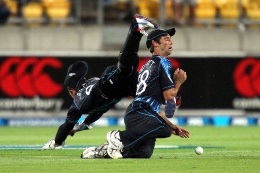 Grant Elliott (right) and Brendon McCullum fall over eachother trying to take a catch in Wellington on February 15, 2013