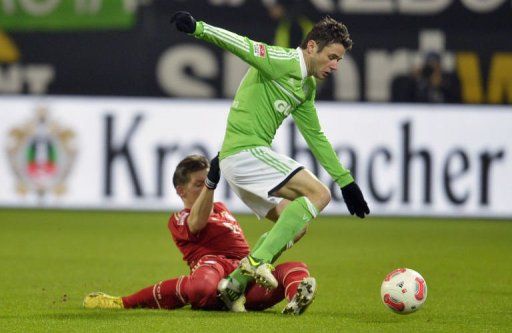 Wolfsburg&#039;s Christian Traesch (R) and Bayern Munich&#039;s Bastian Schweinsteiger fight for the ball on February 15, 2013